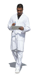 cut out indian doctor walking and holding a tablet