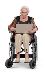 elderly lady sitting in a wheelchair and holding a laptop