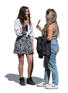 two women standing and eating ice cream