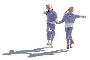 two backlit girls walking playfully