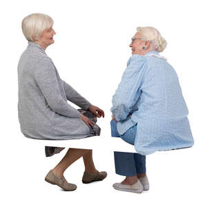 two older grey haired women sitting and talking