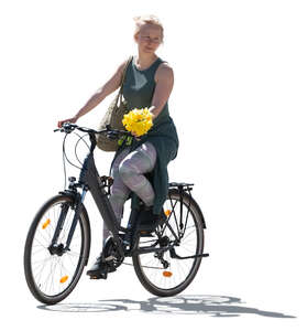 cut out backlit woman holding flowers riding a bike
