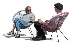 two people sitting in an outdoor cafe