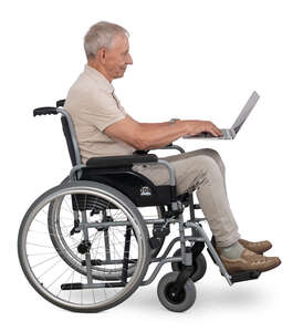 older man sitting in a wheelchair and working with computer