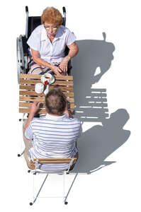top view of two older people sitting in a cafe