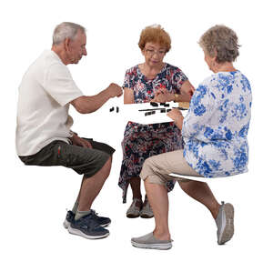 cut out group of three senior people sitting and playing domino