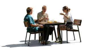 cut out backlit group of three people sitting in a cafeteria and eating