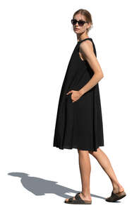 cut out woman in a black dress standing and looking back over the shoulder