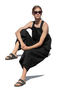 cut out woman in a black summer outfit sitting