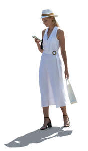 cut out backlit woman in a white dress and wearing a hat standing