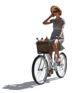 cut out backlit woman with a hat riding a bike