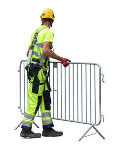 worker lifting a barrier fence