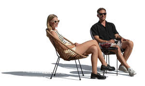 man and woman sitting on balcony chairs outside in the sunlight