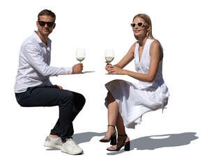 man and woman sitting in a restaurant in summer and drinking wine