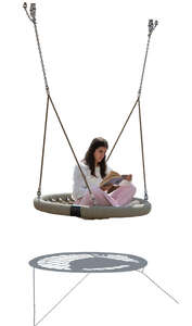 backlit woman sitting in an outdoor swing and reading