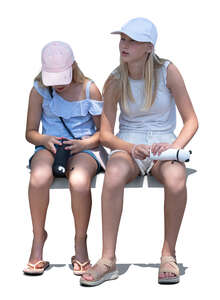 two little girls sitting in partial light