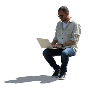 cut out backlit man with a laptop sitting