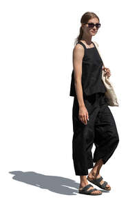 cut out woman in black summer clothes walking