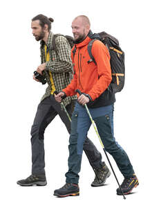 two cut out men with trekking poles and backpacks hiking