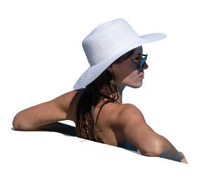 woman with a hat relaxing in the pool