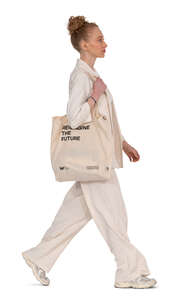 cut out woman in a beige linen suit walking