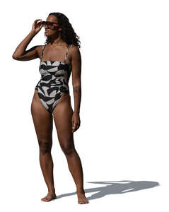 woman in a swimsuit standing and looking into the distance