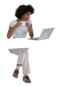 woman sitting behind the desk with laptop and coffee