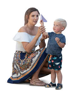 mother and son playing with paper planes