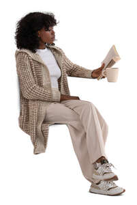 woman wearing a comfy cardigan sitting and reading a book