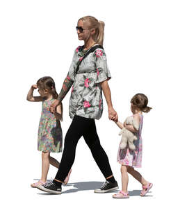 woman with two little girls walking hand in hand