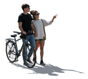 cut out backlit couple with a bike walking hand in hand