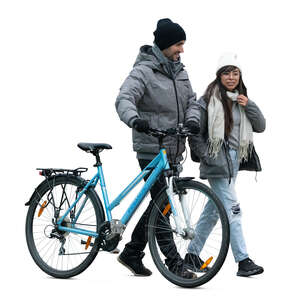 man with a bike walking with a girl in cold weather