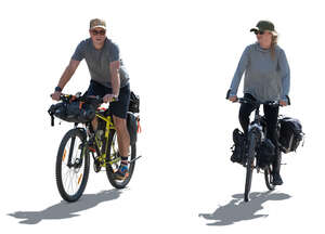 two backlit bikers with travel bags