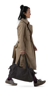 asian woman in a trenchcoat walking