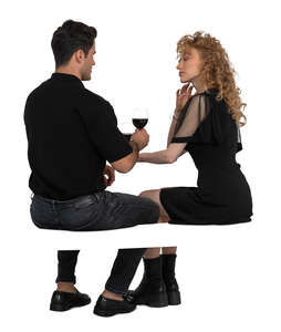 man and woman sitting in a restaurant and drinking wine