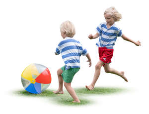 two boys playing with a ball on the grass