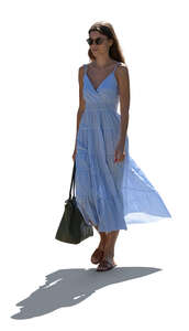 cut out backlit woman in a summer dress walking