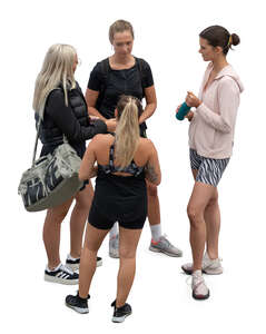 top view of four women standing and talking after workout