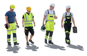 group of backlit construction workers walking