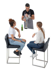 two women sitting in the bar and talking to a barman