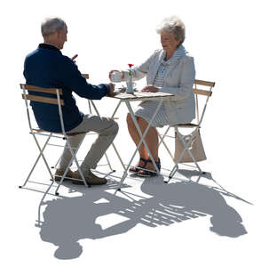 cut out backlit elderly couple sitting in a cafe