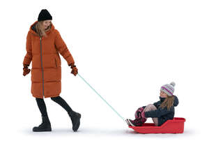 girl sitting on a sledge and mother pulling the sledge