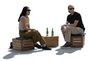 backlit man and woman sitting in a casual hipster cafe