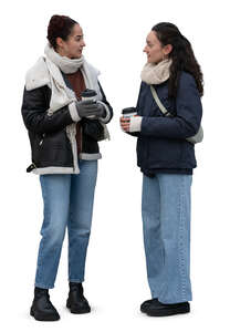 two girls in winter standing and drinking coffee