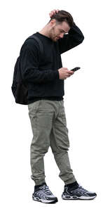 cut out young man standing and checking his phone