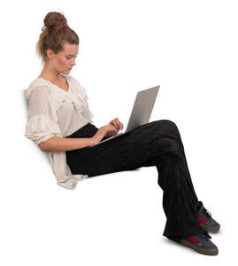 woman sitting on a sofa and working with a laptop