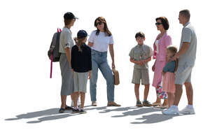 backlit group of adults and children standing