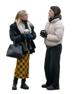 two women standing outside in late autumn and drinking coffee