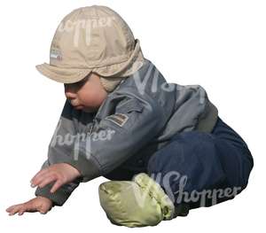 small boy playing on the ground