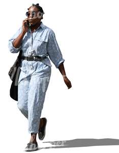 black woman walking and talking on the phone